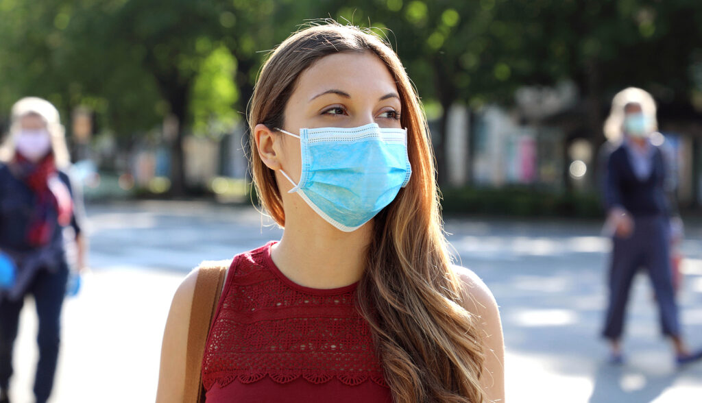 Woman in city street wearing surgical mask